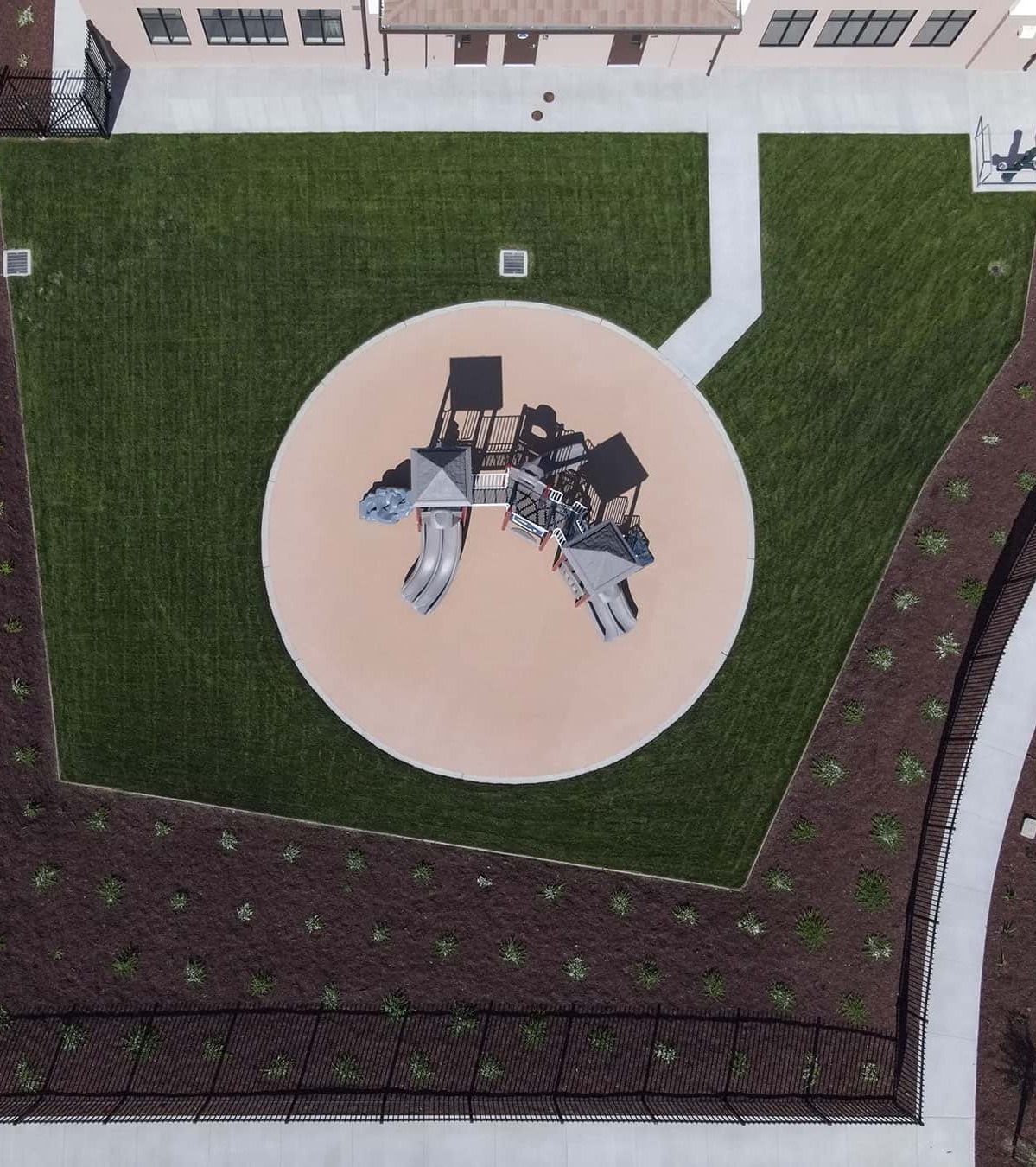 Aerial view of commercial landscape installation featuring playground areas, turf, and site amenities maintained by K&D Landscaping