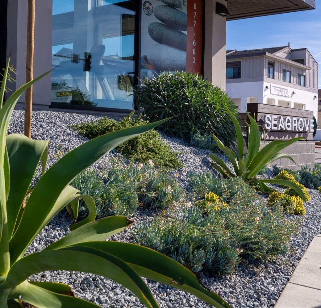 Commercial apartment courtyard featuring planting beds and outdoor seating installed by K&D Landscaping Commercial apartment courtyard featuring planting beds and outdoor seating installed by K&D Landscaping