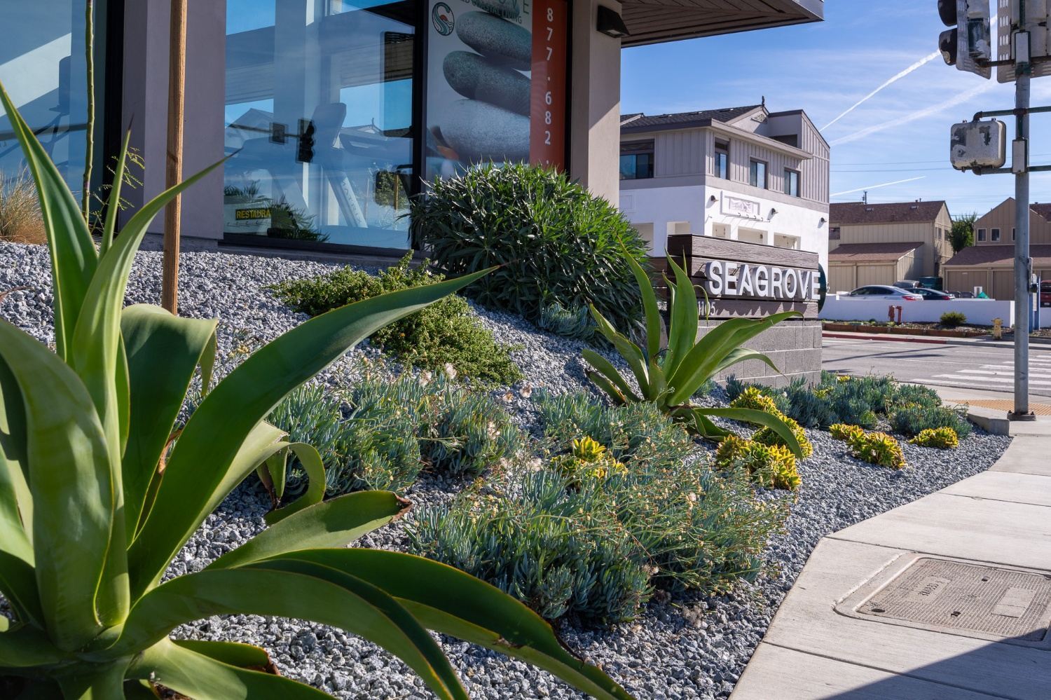 Commercial apartment courtyard featuring planting beds and outdoor seating installed by K&D Landscaping