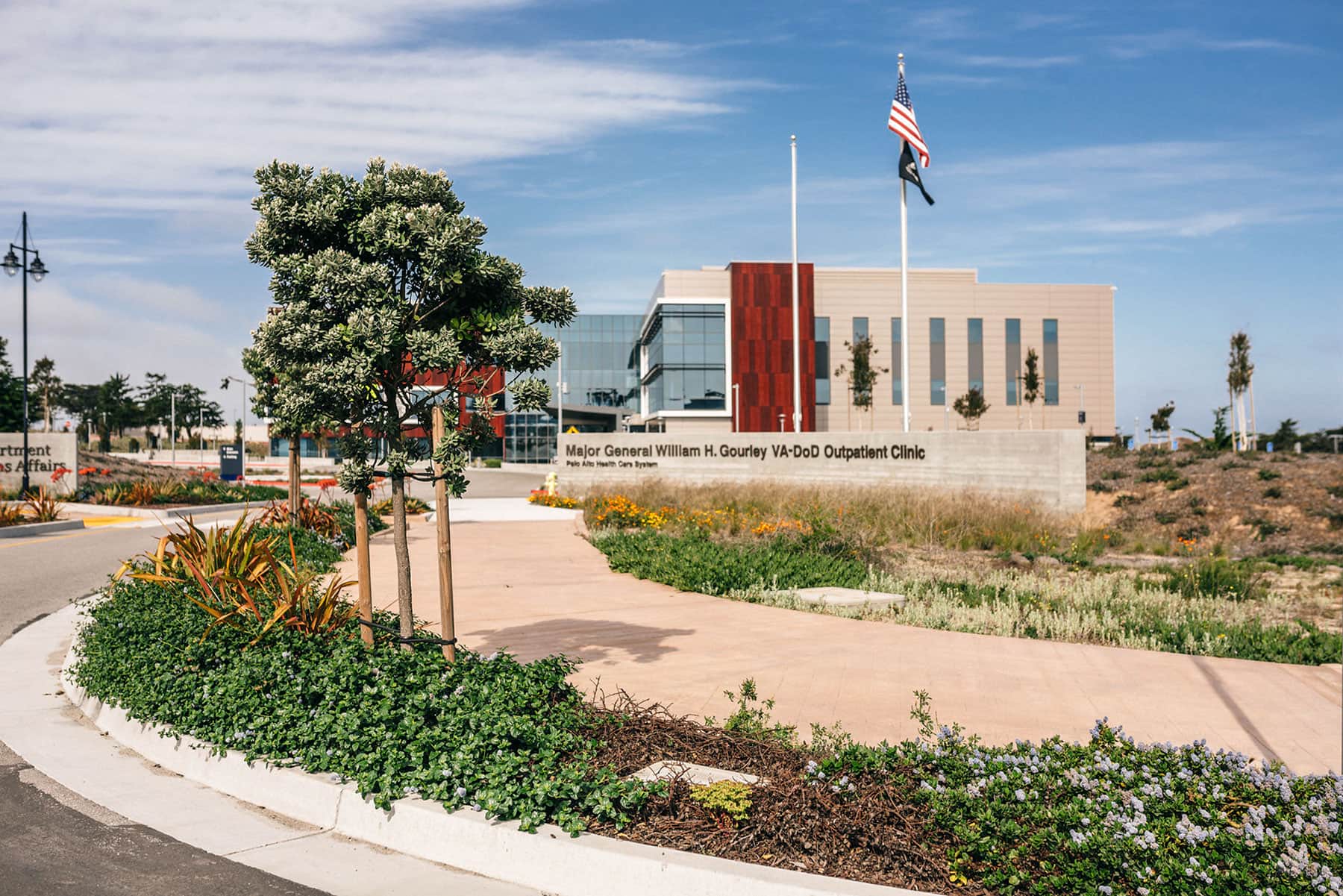 K&D Landscaping modern hospital building exterior with native plantings, boulders, and drought-tolerant landscape design