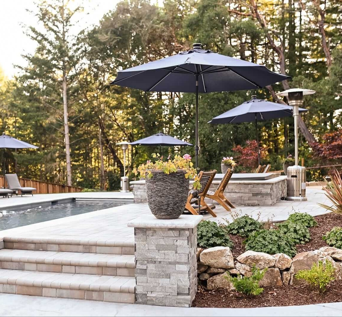 Custom paver patio and poolscape with integrated hardscaping and outdoor living spaces by K&D Landscaping