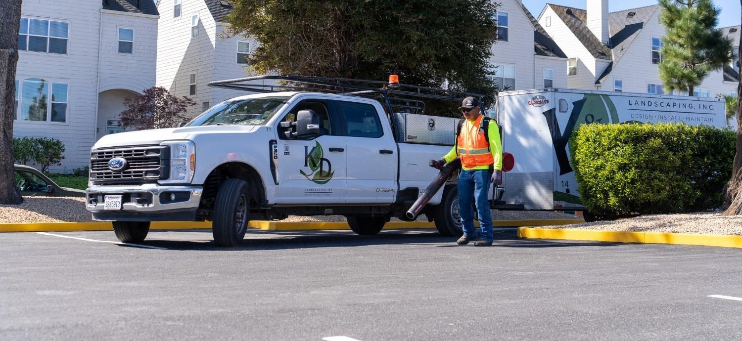 Landscape maintenance crew servicing commercial property grounds for K&D Landscaping