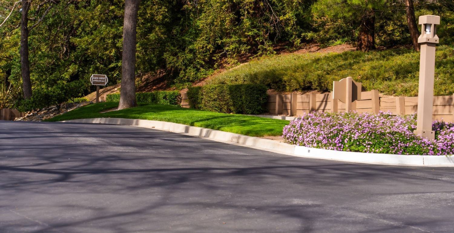 Neighborhood landscape managed by K&D Landscaping with healthy shrubs and seasonal color