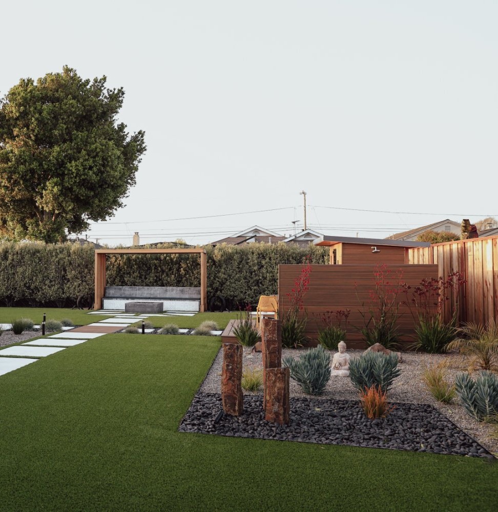 Outdoor gathering space with decking and landscape improvements by K&D Landscaping