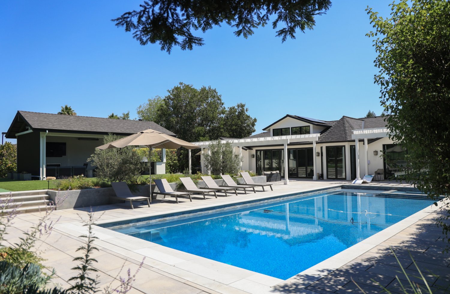 Outdoor living environment designed around recreation and family gatherings by K&D Landscaping