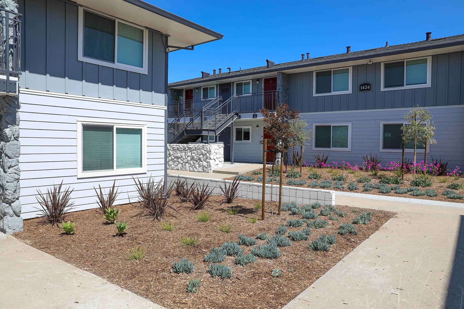 Apartment community entrance featuring landscape enhancements by K&D Landscaping