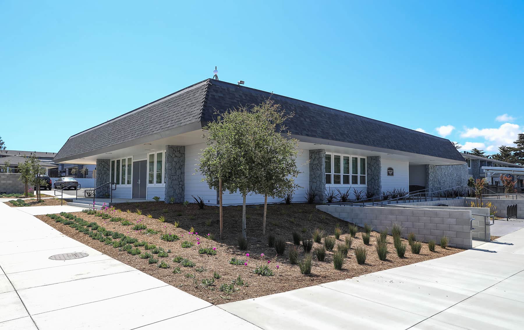 Apartment complex landscaping with drought-conscious planting design by K&D Landscaping