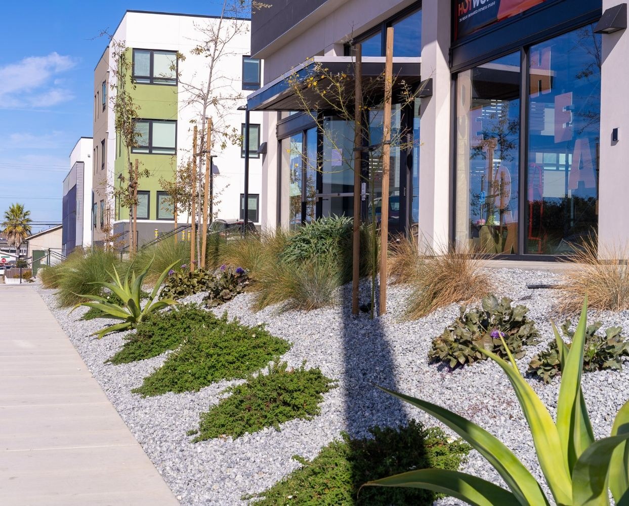 Apartment exterior improved through landscape construction and irrigation installation by K&D Landscaping