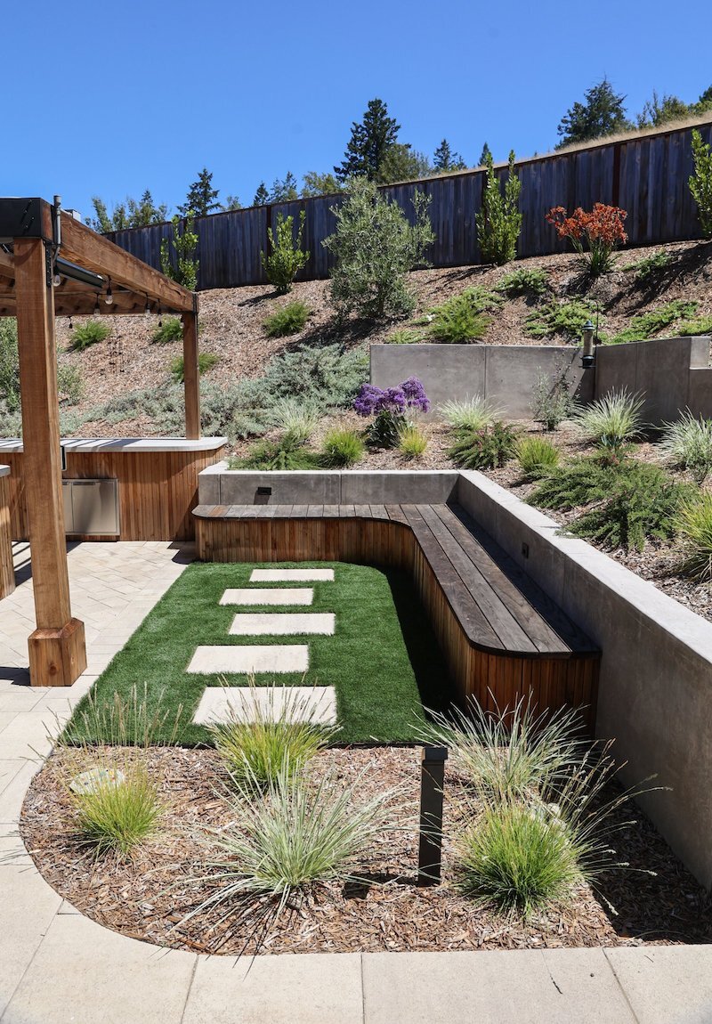 Artificial lawn connected to planting beds and edible garden areas by K&D Landscaping