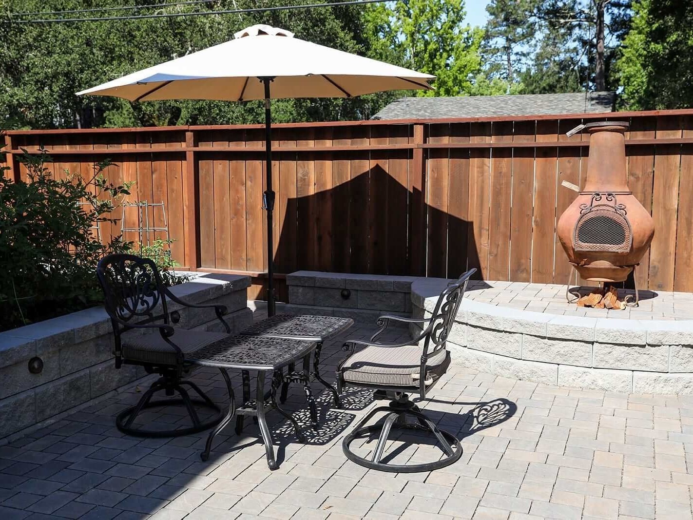 Built-in barbecue station with surrounding paver hardscape by K&D Landscaping