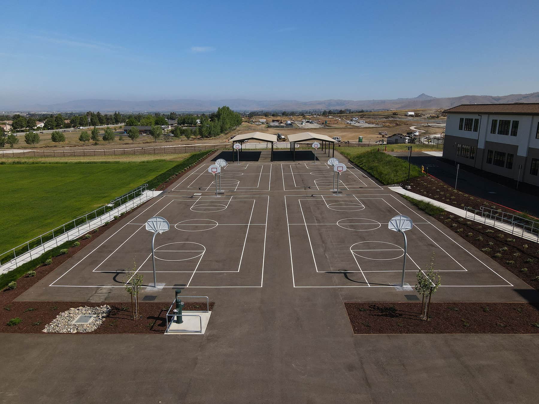 Commercial landscape project featuring hydroseeded lawn areas by K&D Landscaping