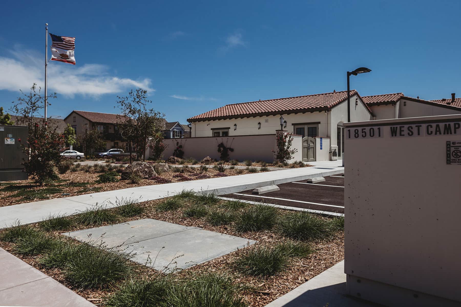 Commercial site landscape with low-water planting, decorative rock, and grounds maintenance completed by K&D Landscaping
