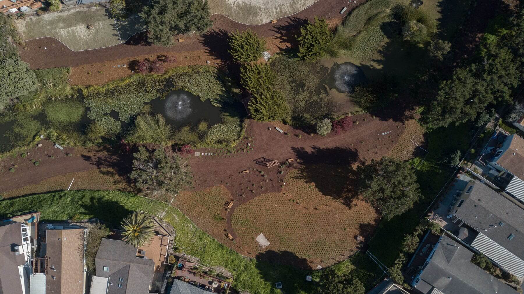 Community park trail with mulch beds and ornamental grasses by K&D Landscaping
