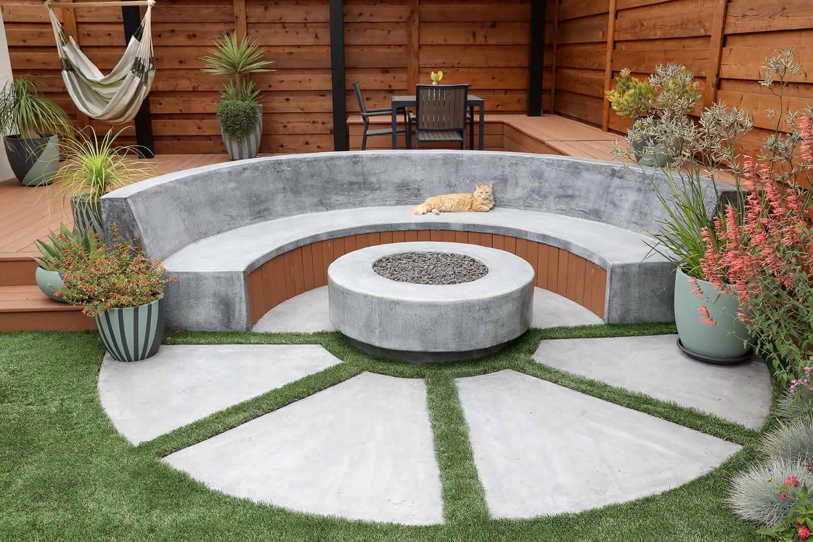 Concrete pathways connecting outdoor living features throughout the property by K&D Landscaping