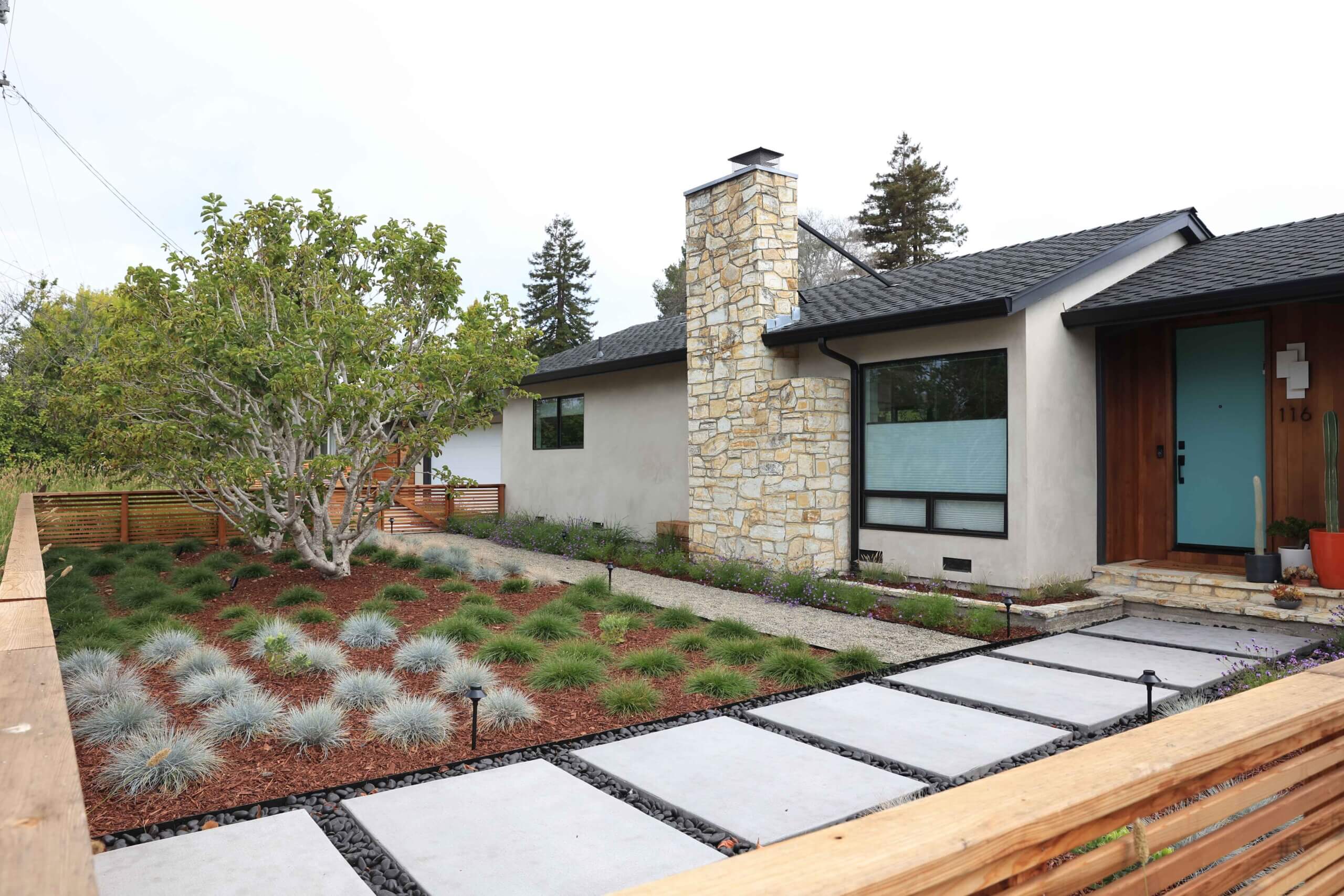 Cozy outdoor seating area surrounded by professionally designed landscape plantings by K&D Landscaping