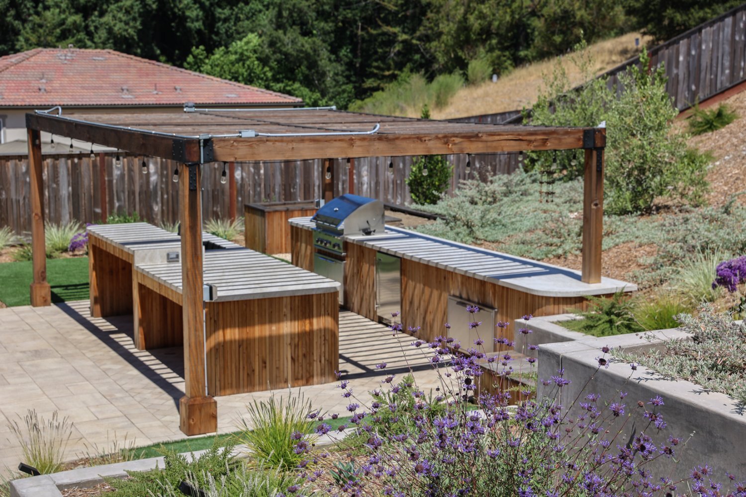 Custom carpentry details incorporated into a hillside landscape project by K&D Landscaping