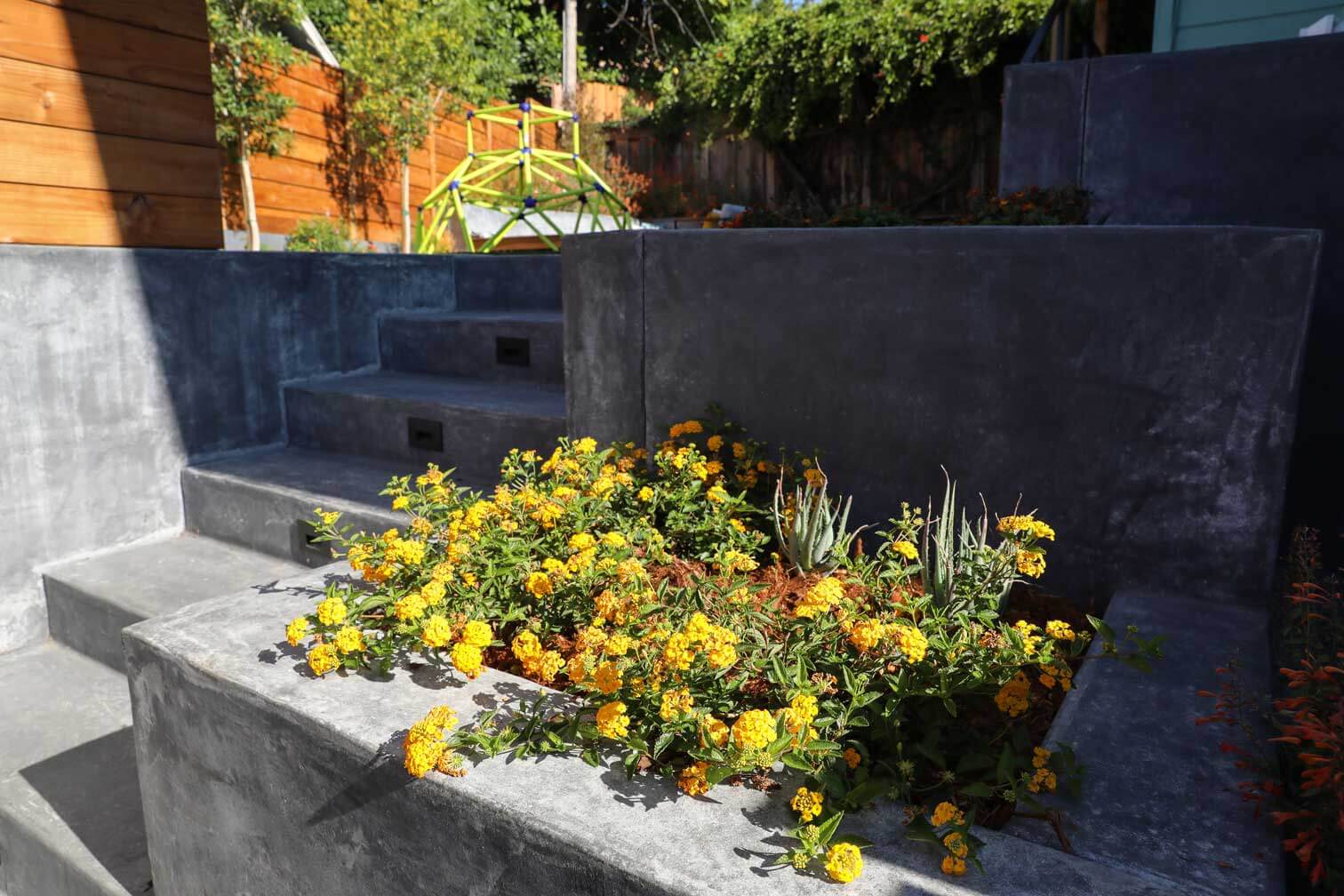Custom fire pit patio surrounded by planting beds and residential hardscape by K&D Landscaping