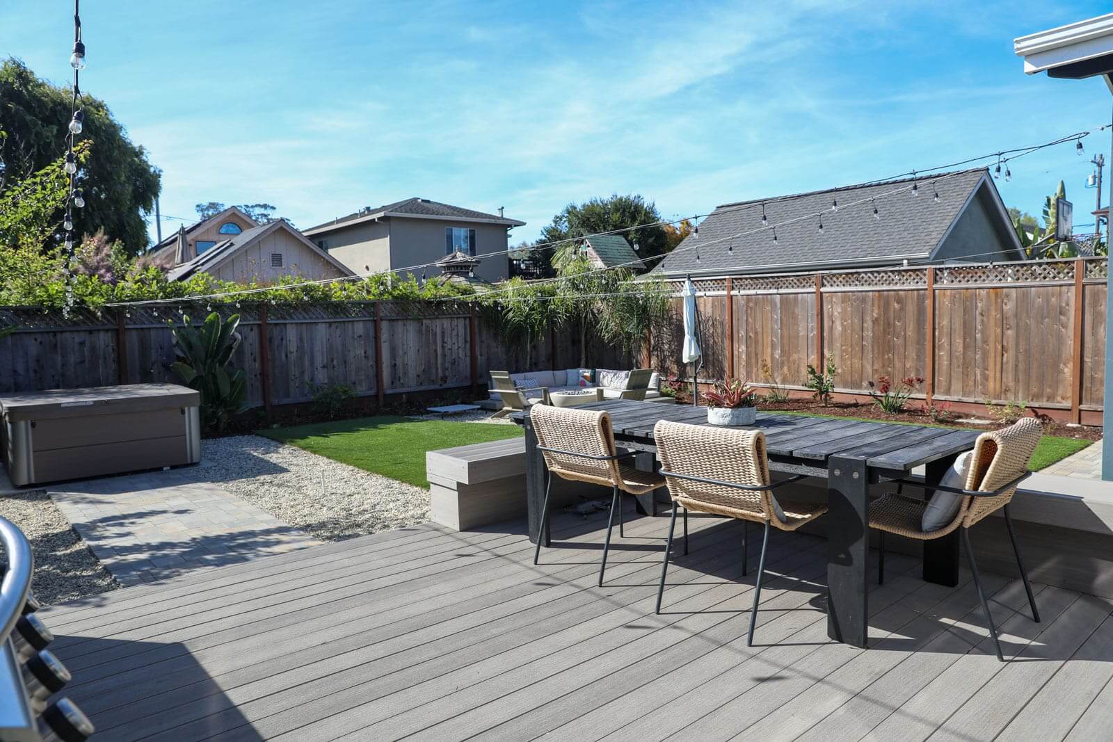 Custom outdoor kitchen and fire pit area designed for residential outdoor living by K&D Landscaping