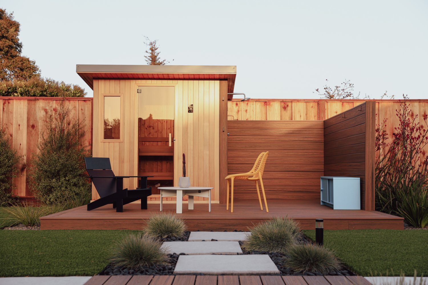 Custom outdoor wellness space featuring sauna lawn and planting areas by K&D Landscaping