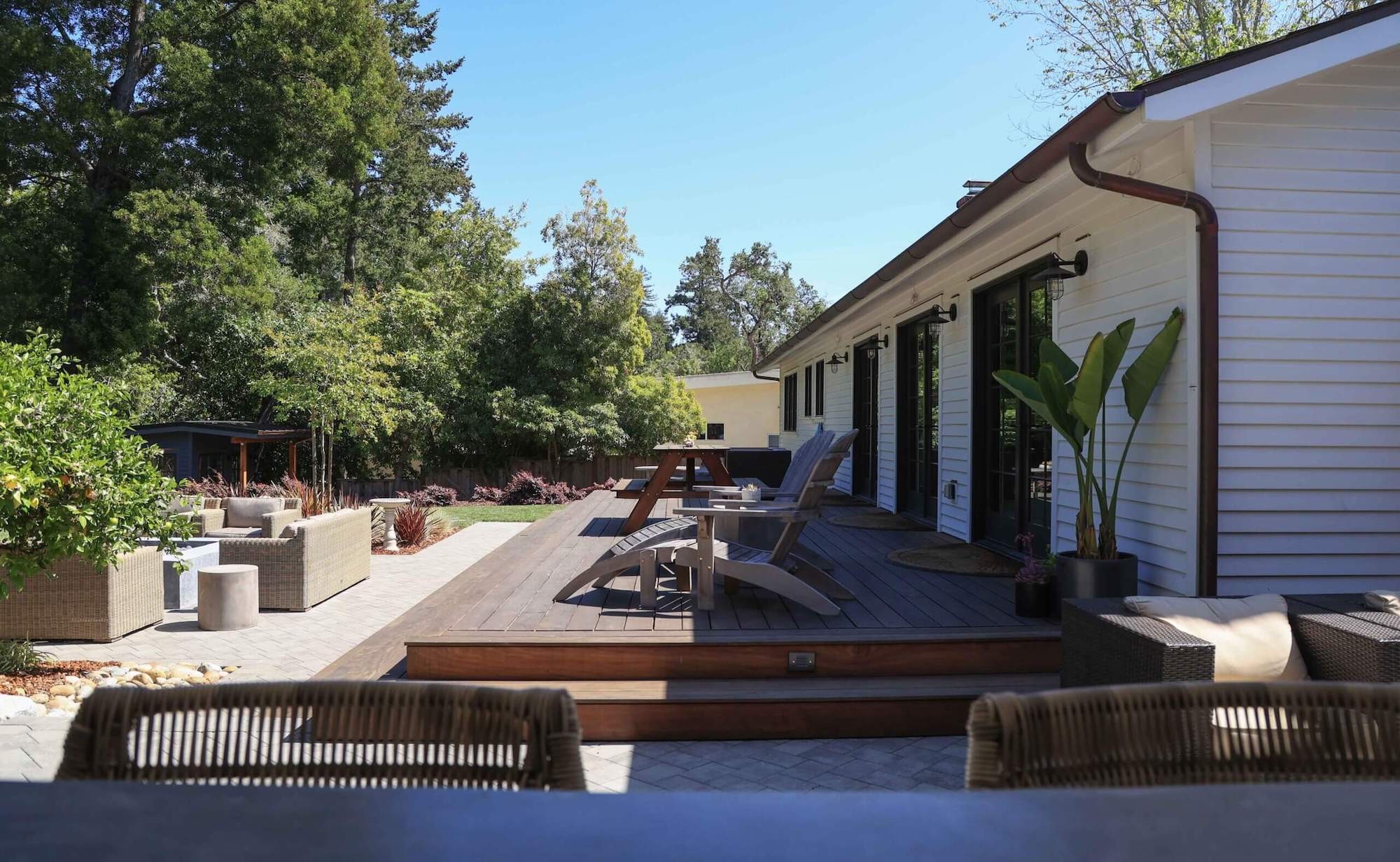 Custom residential landscape featuring decorative plantings and outdoor gathering spaces by K&D Landscaping