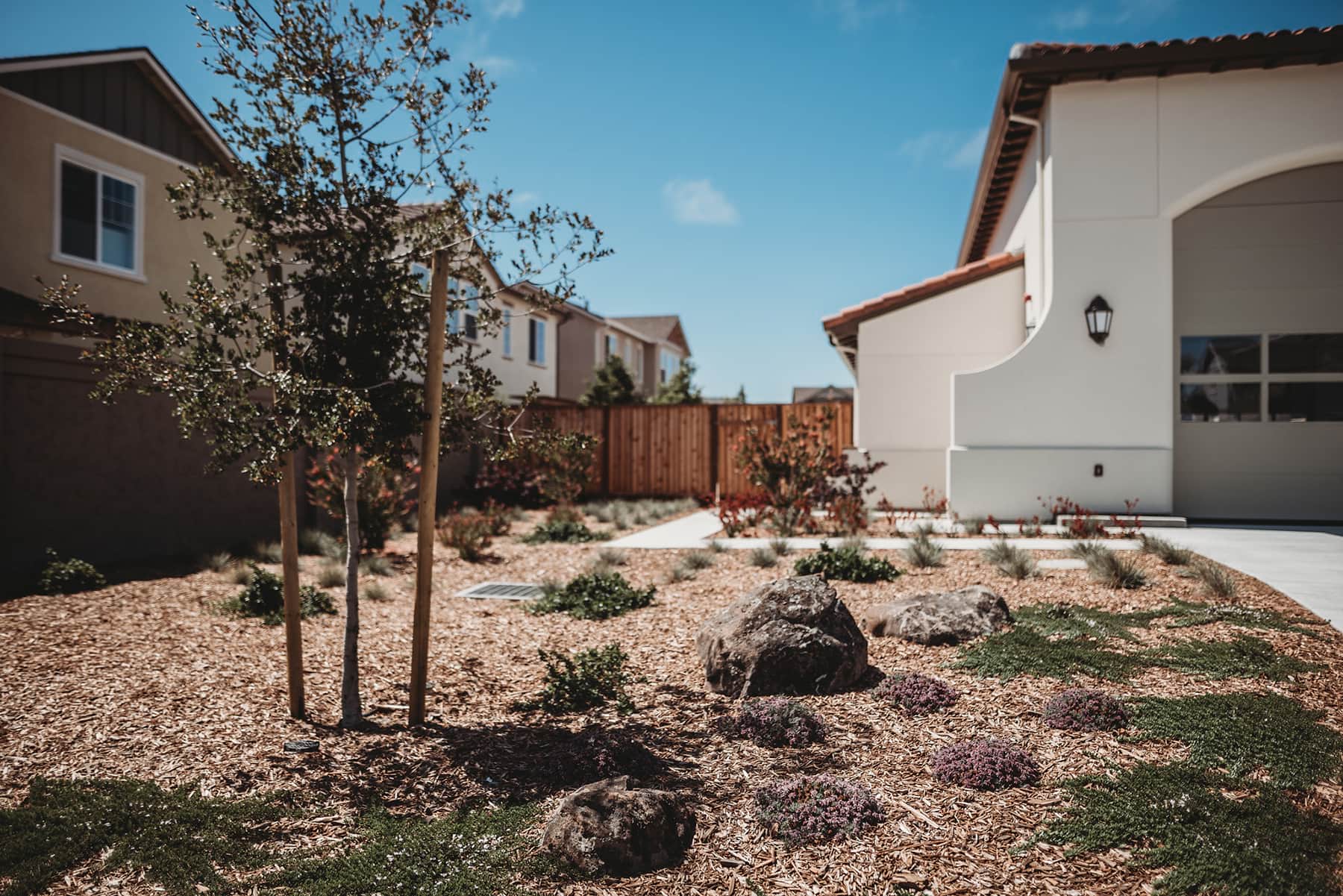 Fire Station landscape with ornamental plantings, gravel groundcover, and young trees installed by K&D Landscaping