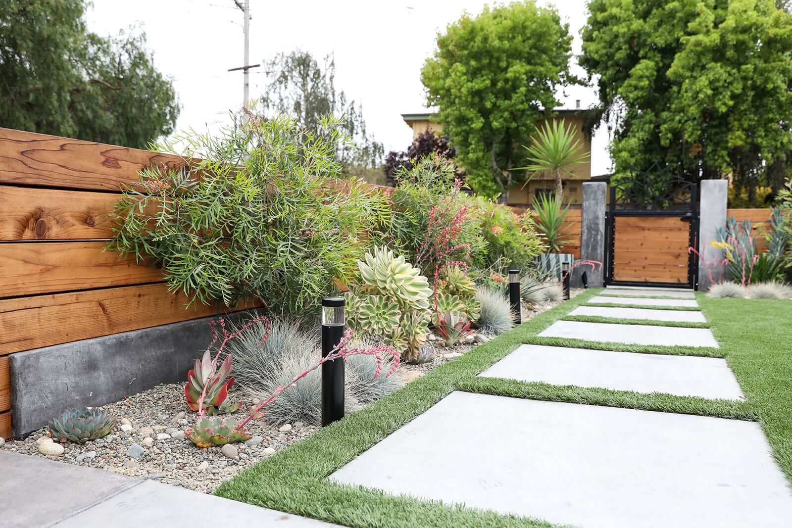 Horizontal redwood fencing framing a residential outdoor living area by K&D Landscaping