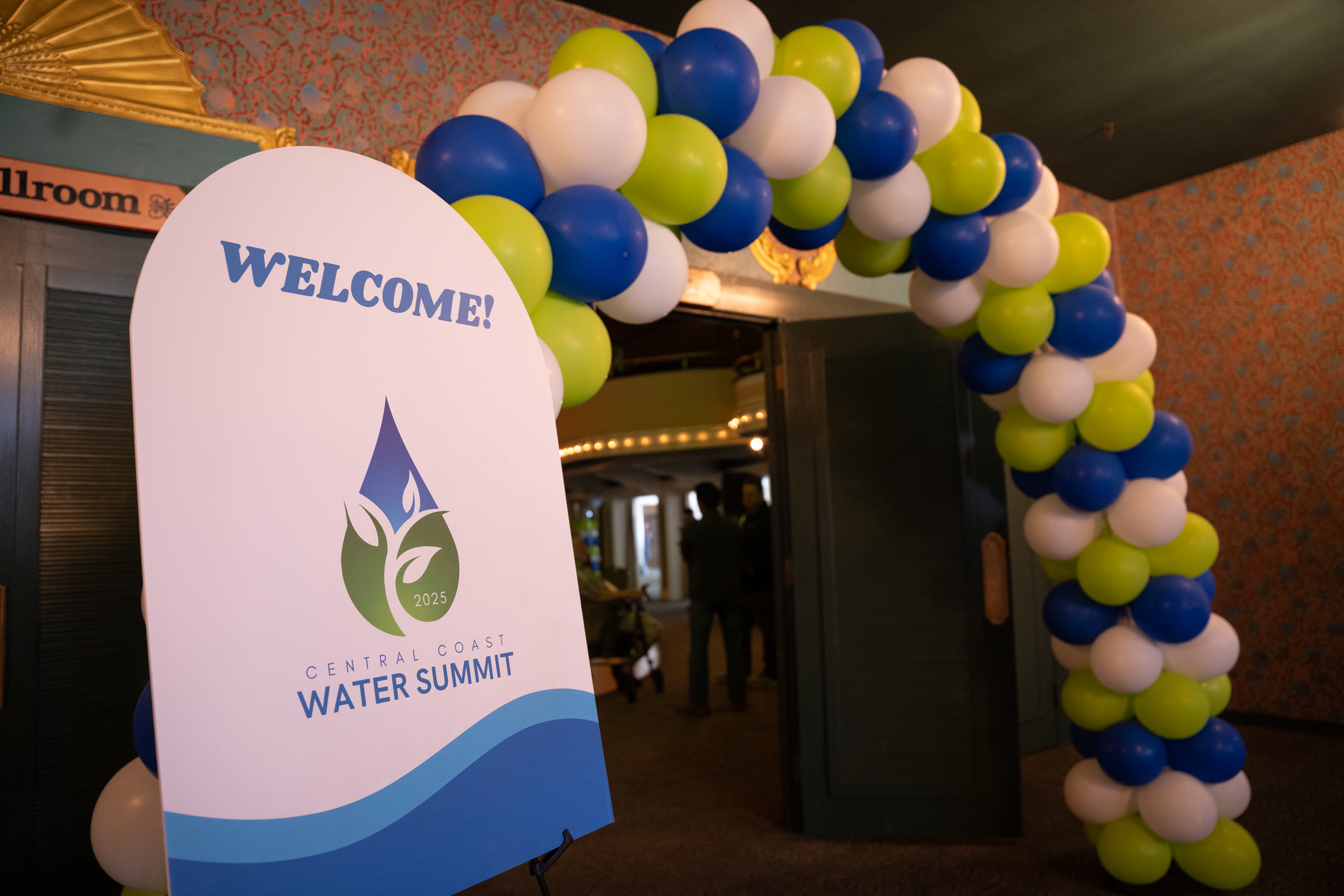 A welcome sign at the 4th Annual Central Coast Water Summit with balloons