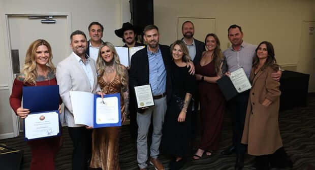 K&D Landscaping team holding award
