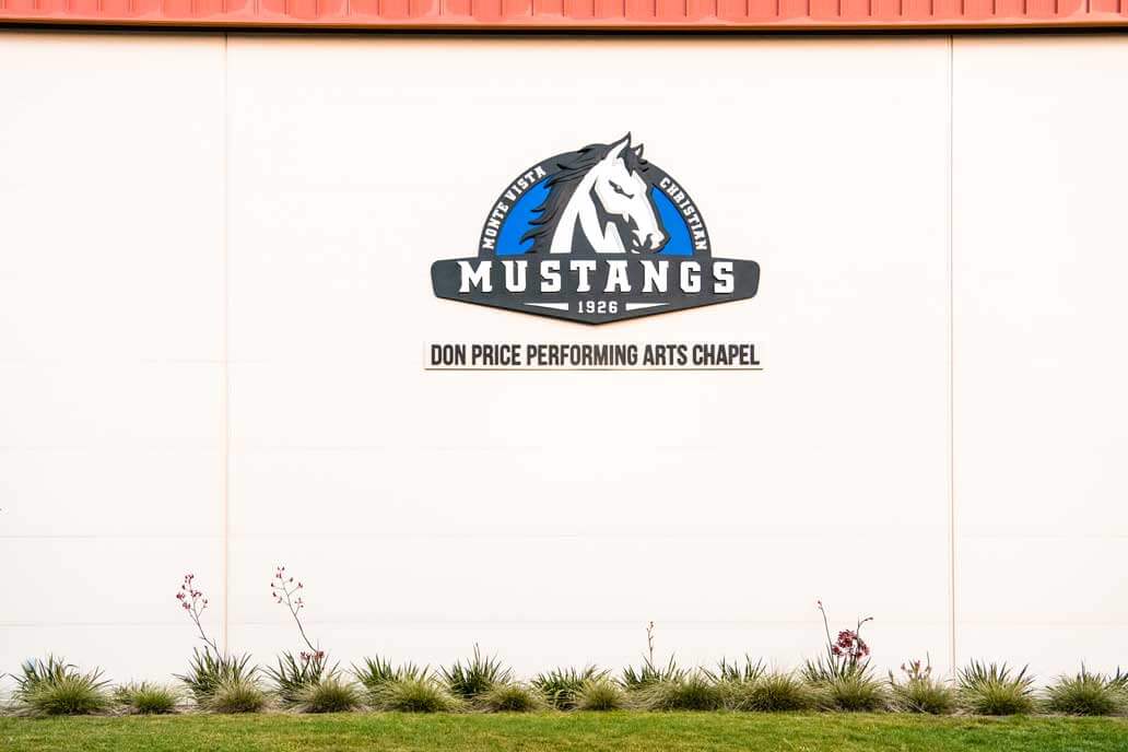 K&D Landscaping Don Price Performing Arts Chapel signage above a flax and ornamental grass border