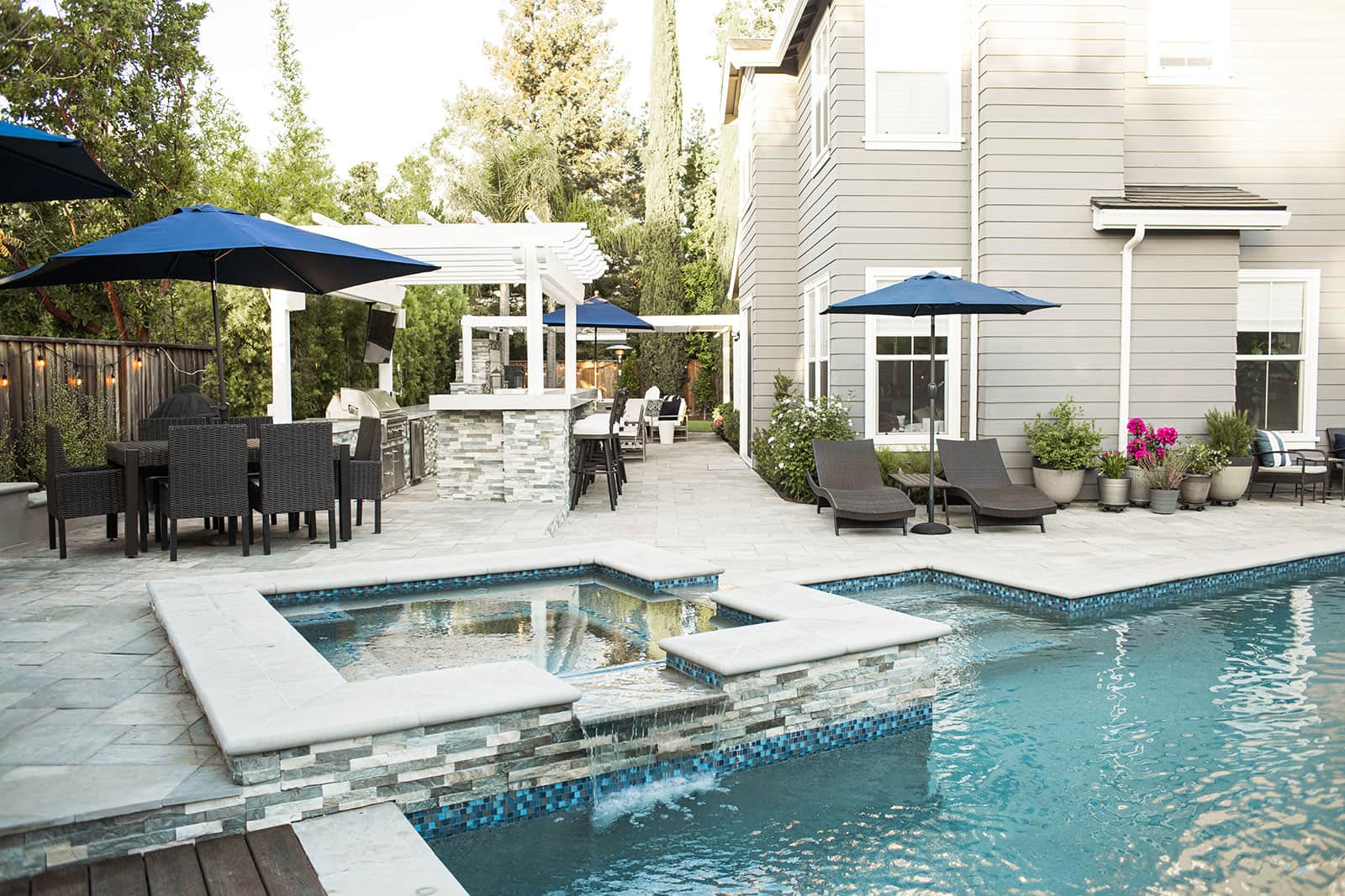 K&D Landscaping artificial turf seating area with landscape lighting and privacy plantings