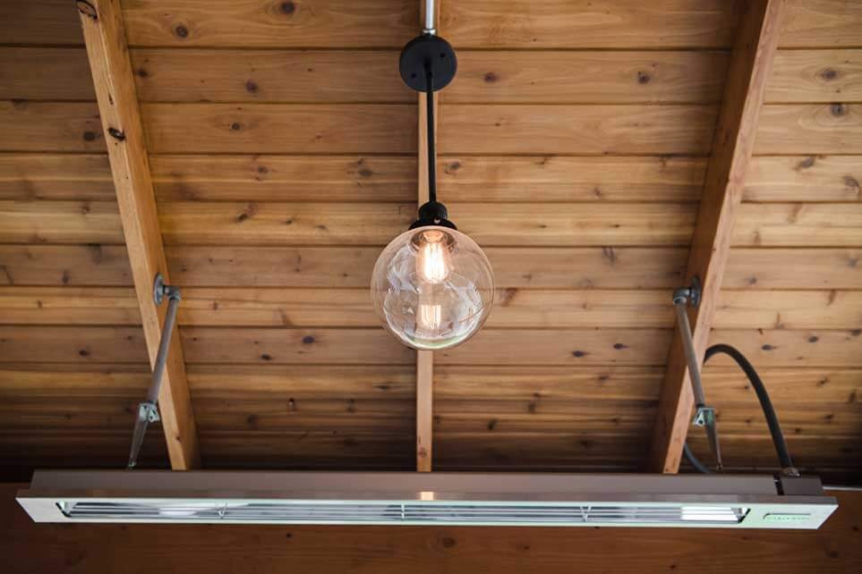 K&D Landscaping globe pendant light and a radiant heater on a cedar pavilion ceiling