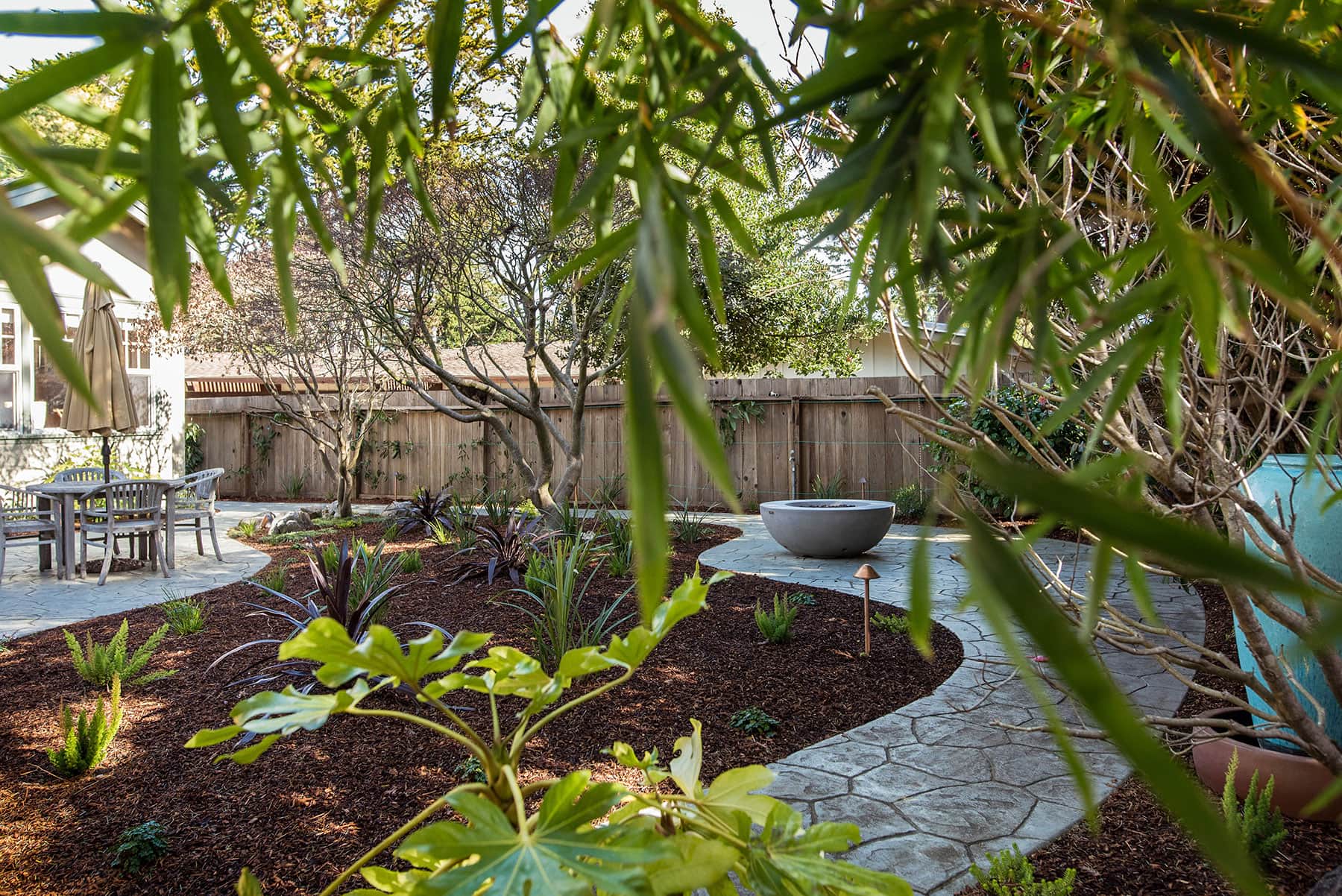 K&D Landscaping landscape design with mulch beds, native plantings, pathways, and shade trees