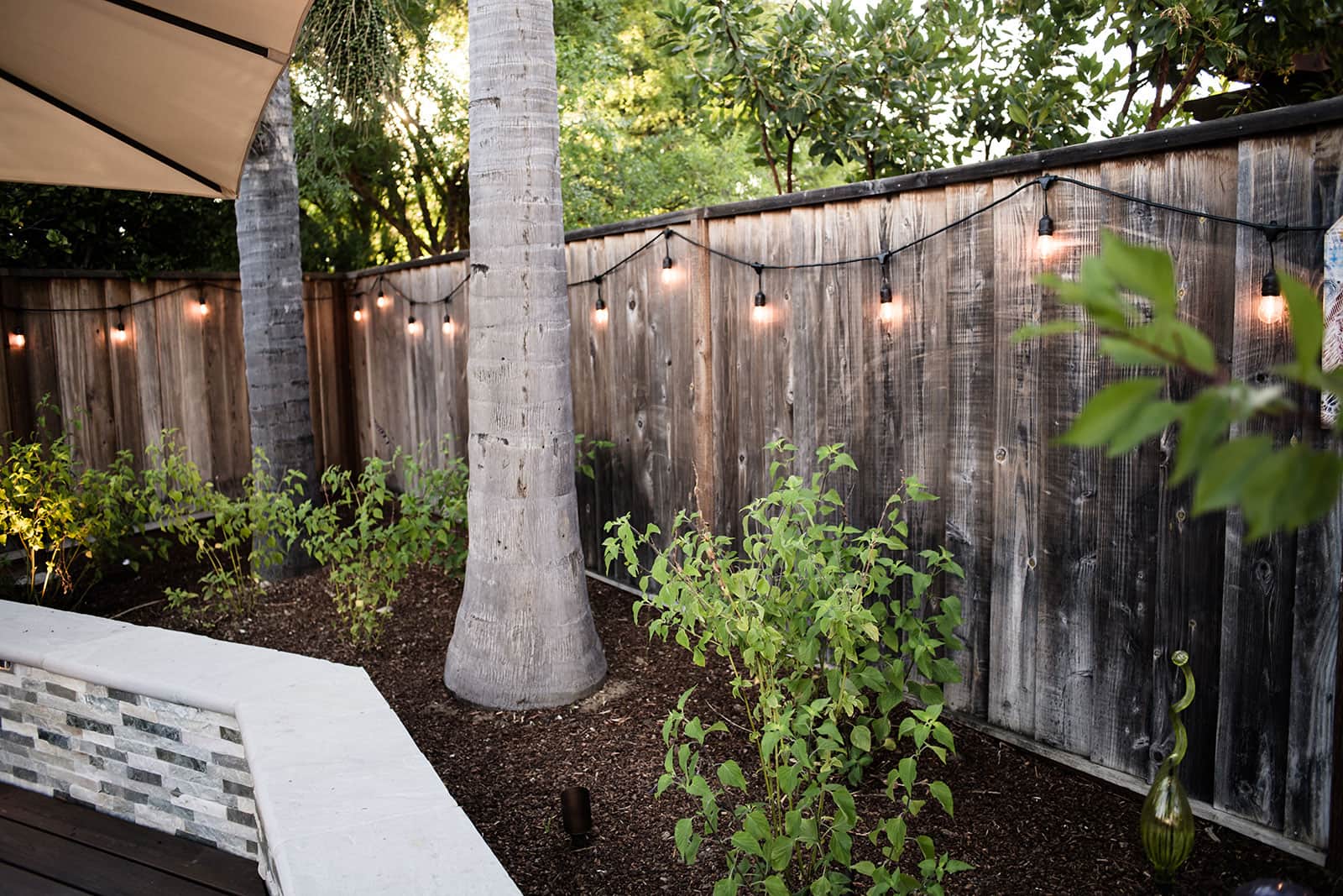 K&D Landscaping landscape lighting installed along planting beds and privacy fencing