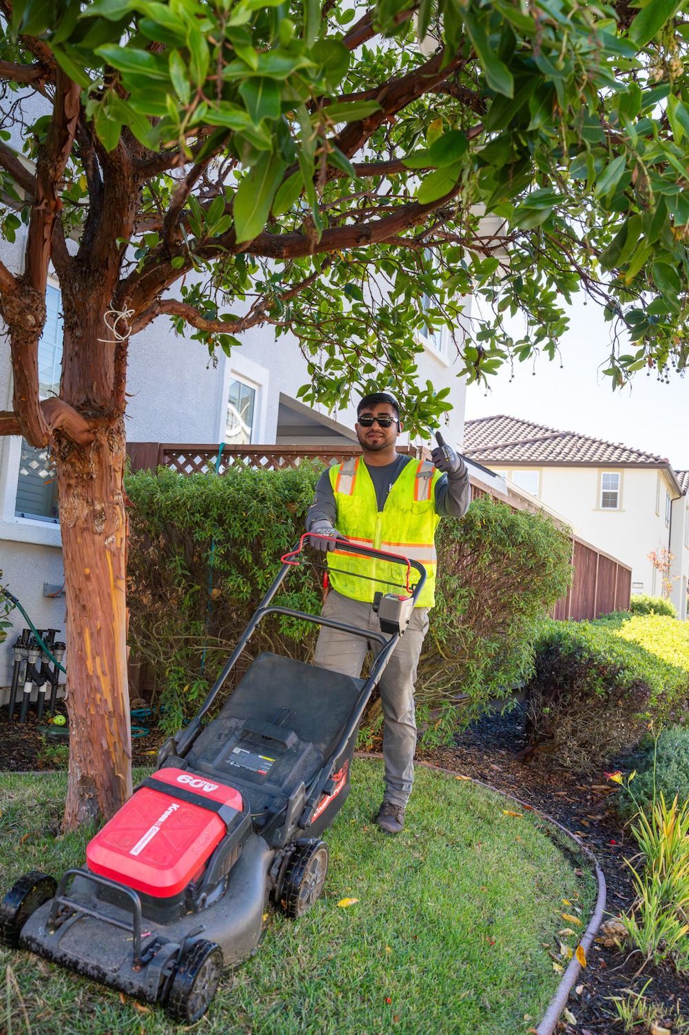 Landscape maintenance professional lawn mowing at commercial property for K&D Landscaping