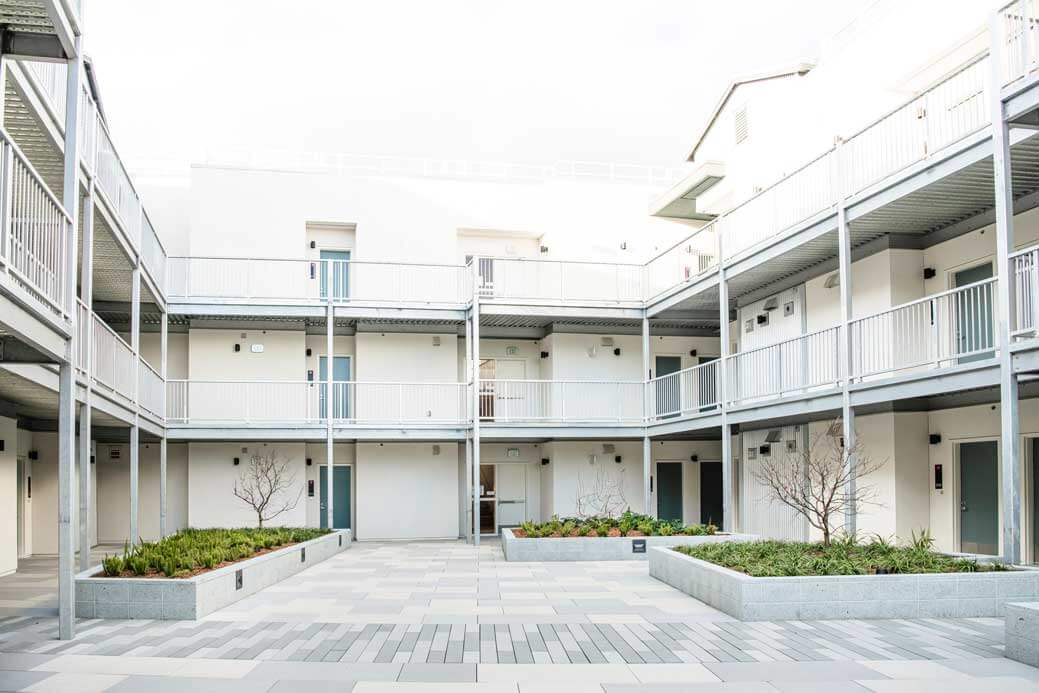 K&D Landscaping modern apartment courtyard with landscape planters and paved gathering space