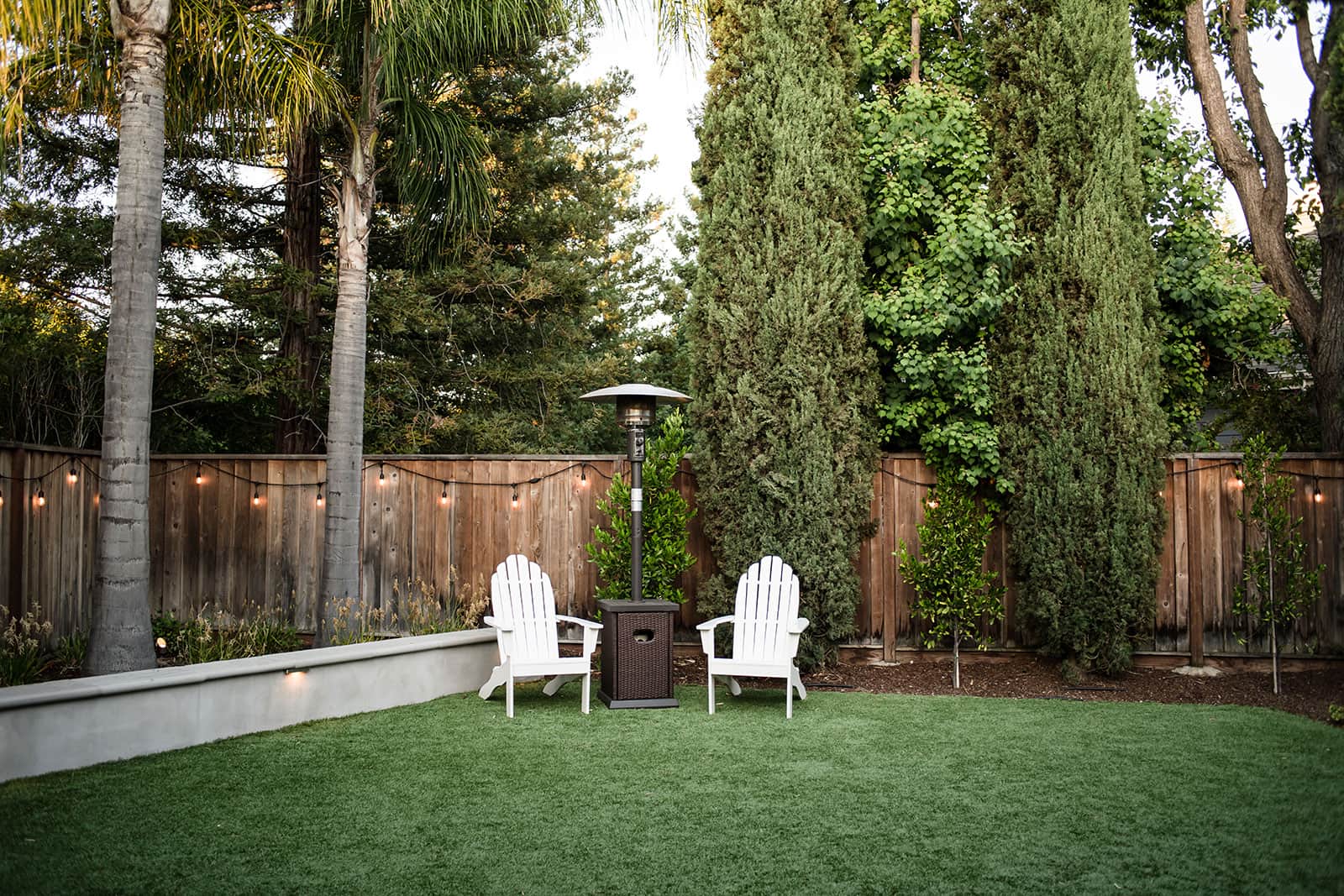 K&D Landscaping outdoor kitchen and entertainment area with custom wood privacy screens