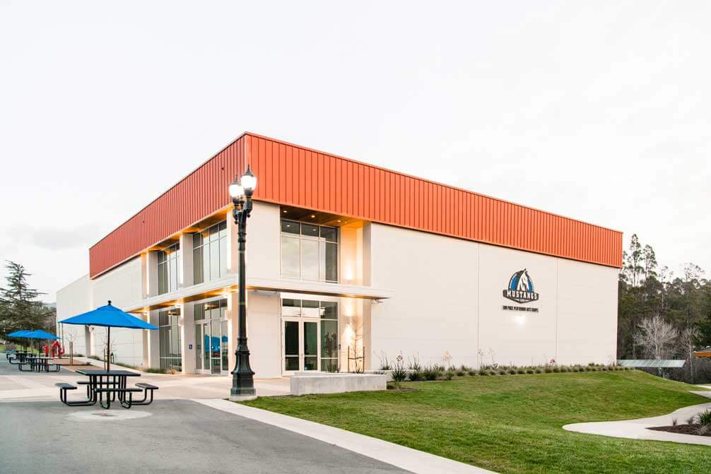 K&D Landscaping performing arts chapel exterior with lawn, ornamental beds and a shaded picnic plaza