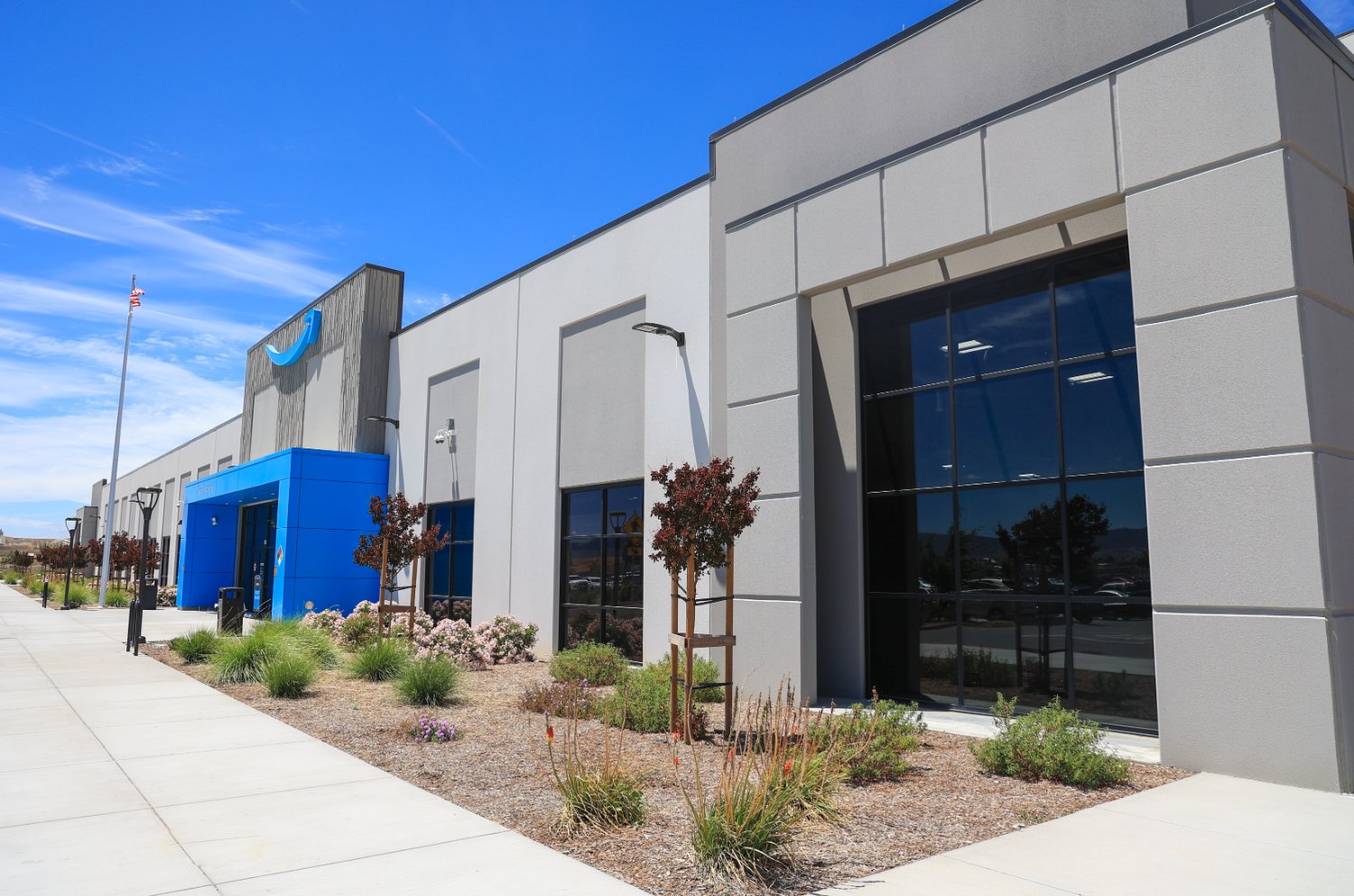 Landscape construction project by K&D Landscaping featuring mulch, shrubs, and irrigation systems