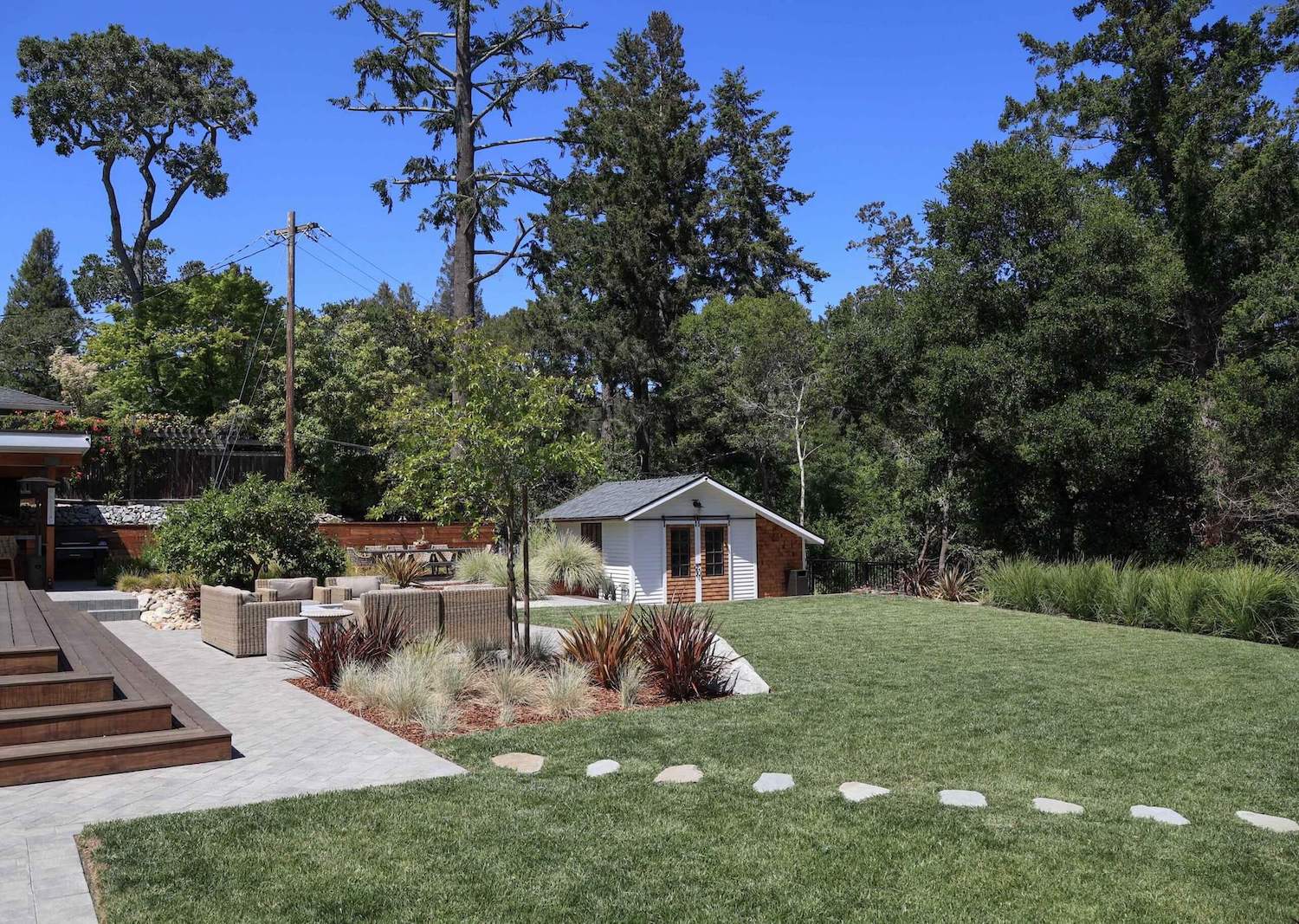 Landscape construction project featuring custom patios, pathways, and planting beds by K&D Landscaping
