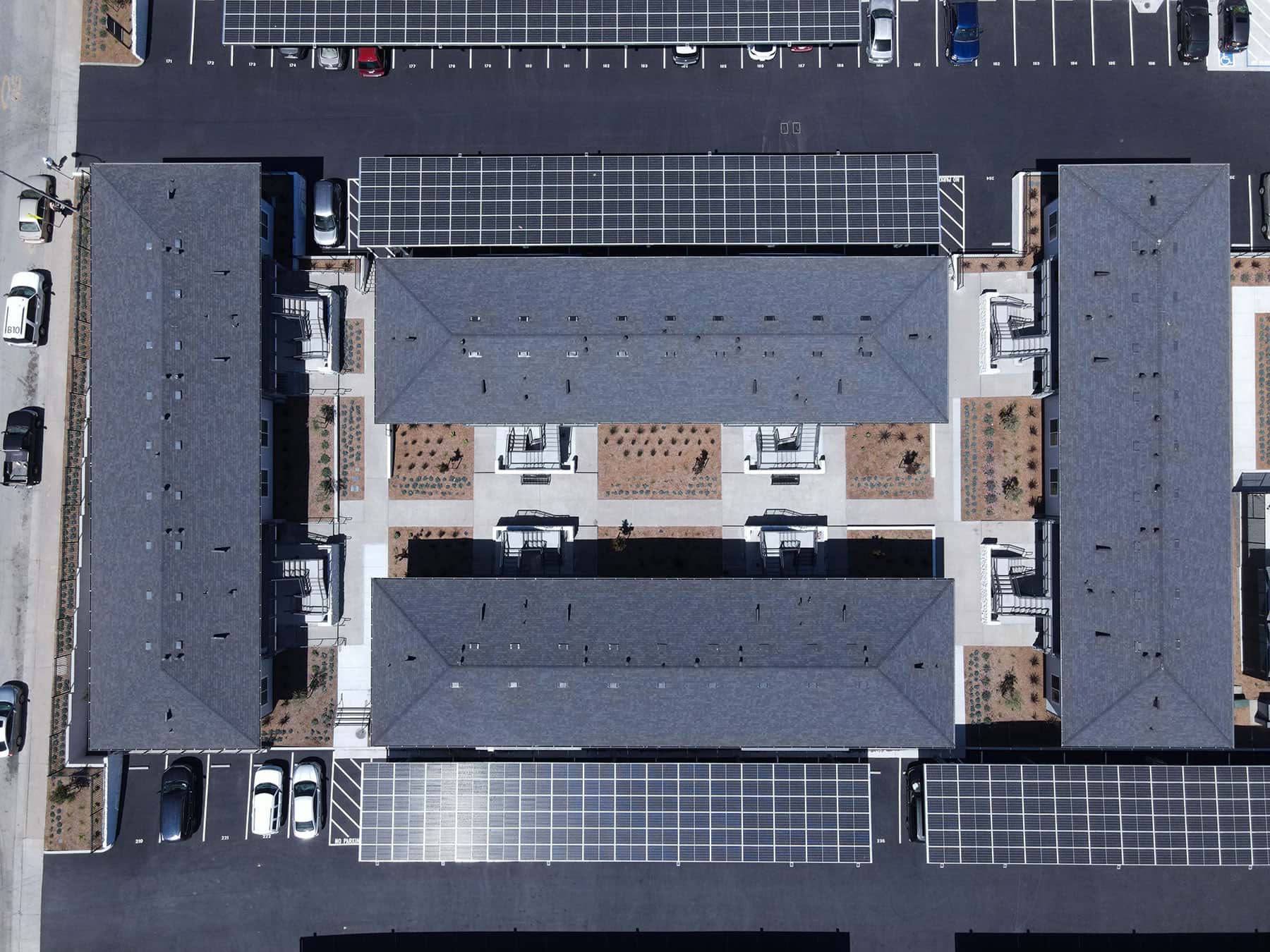 Landscape planting beds surrounding commercial residential buildings by K&D Landscaping