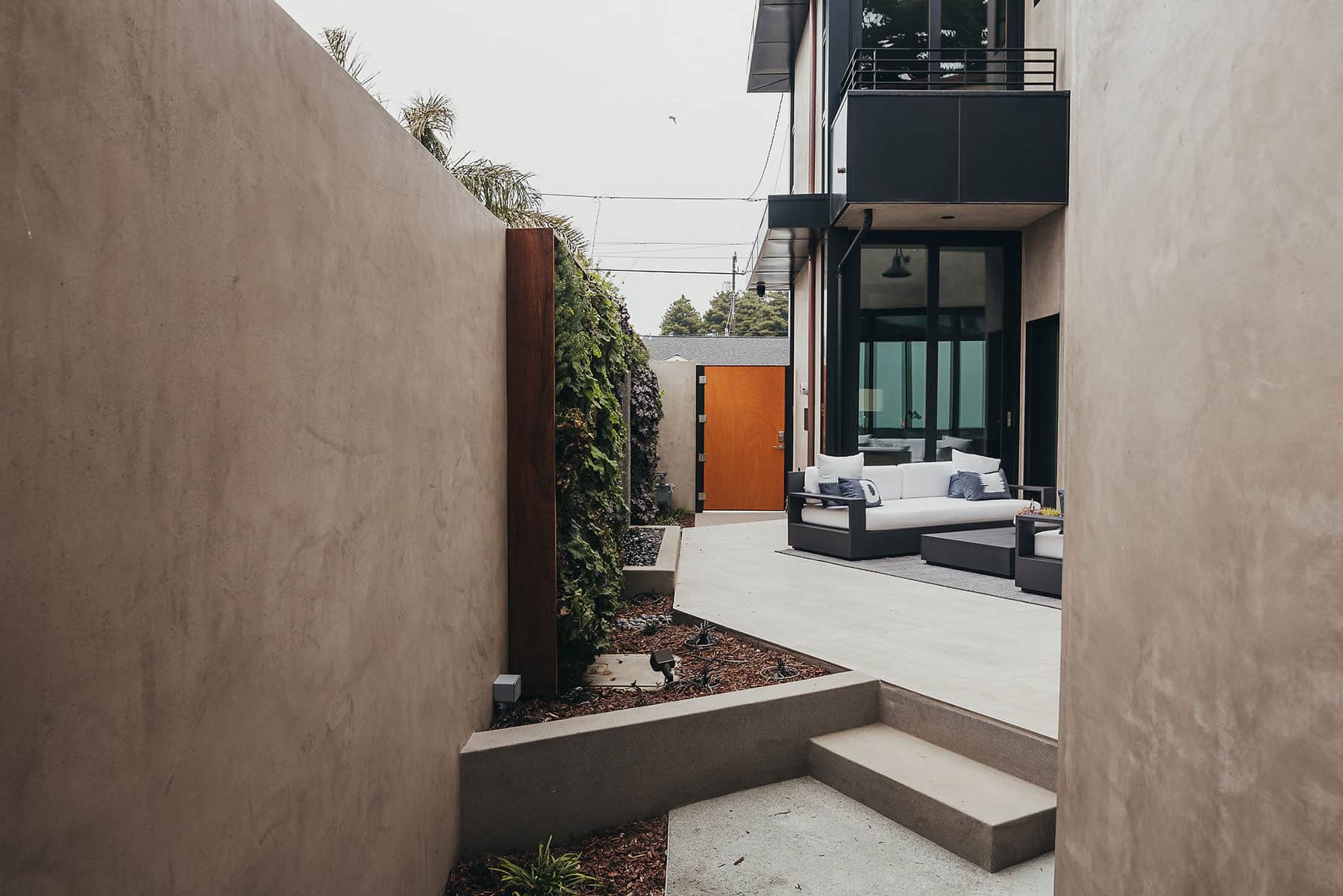 Living wall with mixed plantings, textured concrete wall, and modern landscape design completed by K&D Landscaping in Santa Cruz