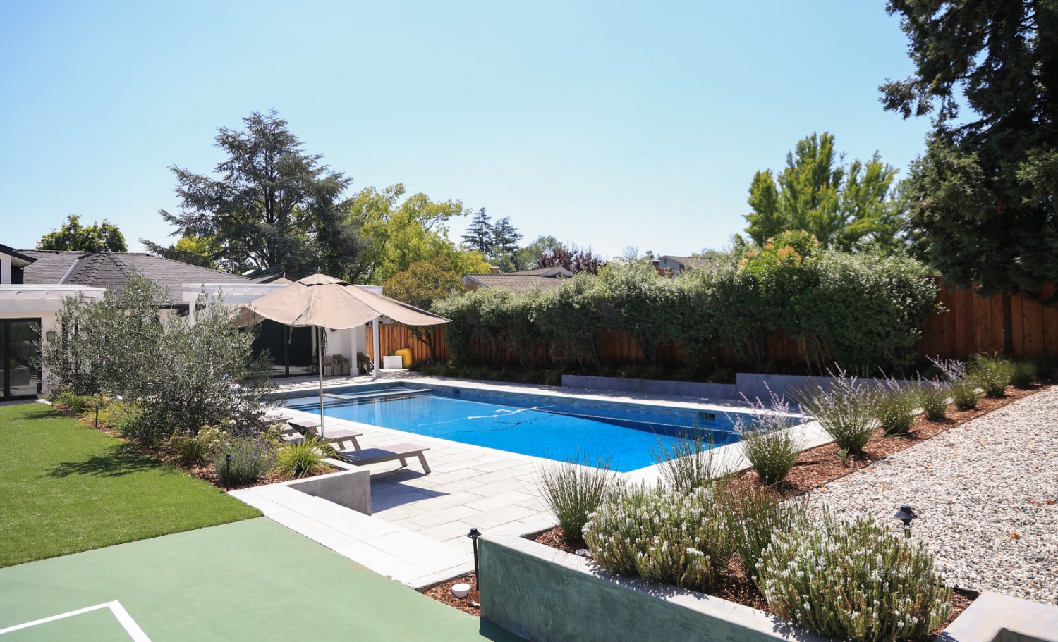 Luxury residential landscape with integrated pool pavilion and pickleball court by K&D Landscaping