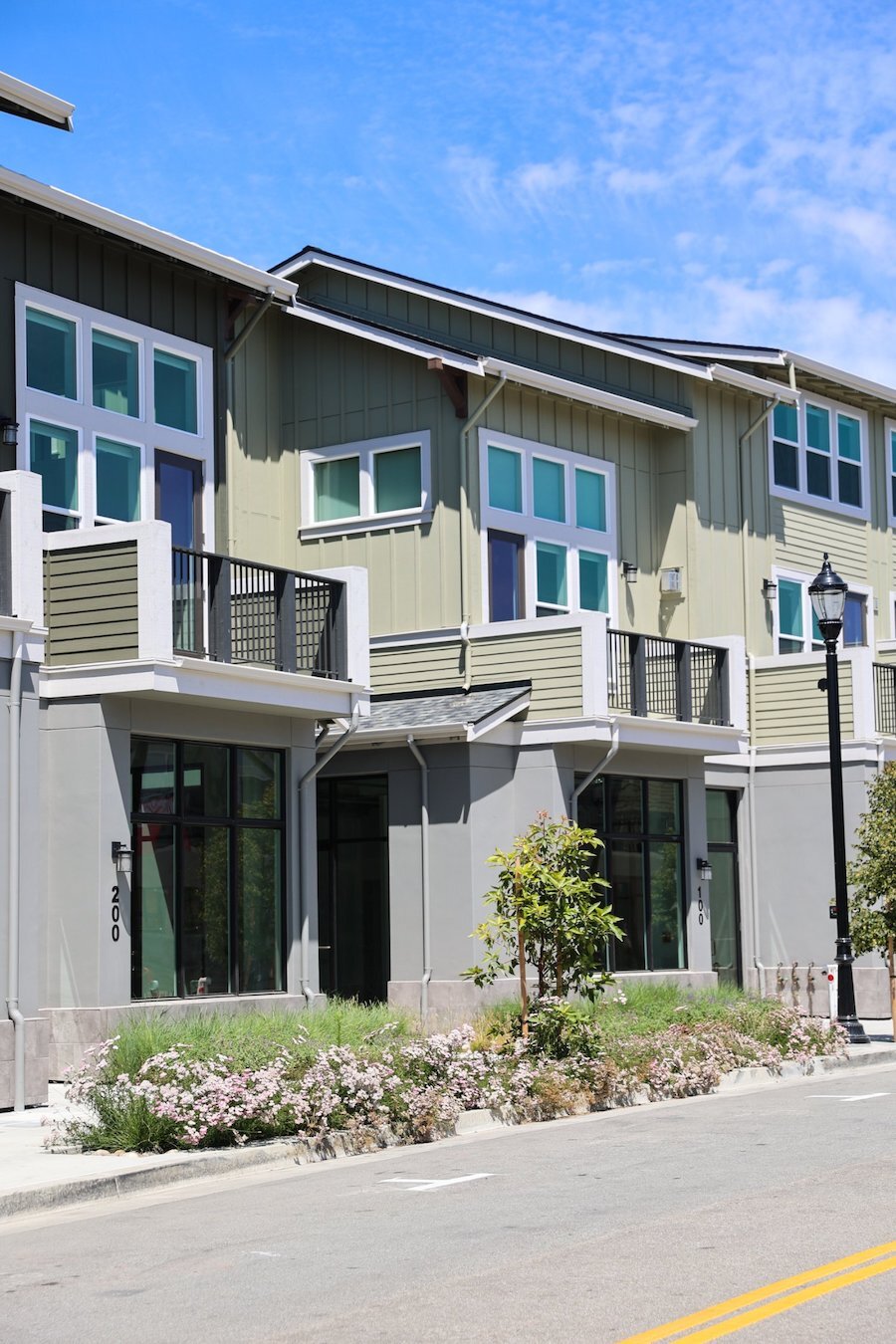 Modern apartment courtyard featuring planting beds and hardscape details by K&D Landscaping