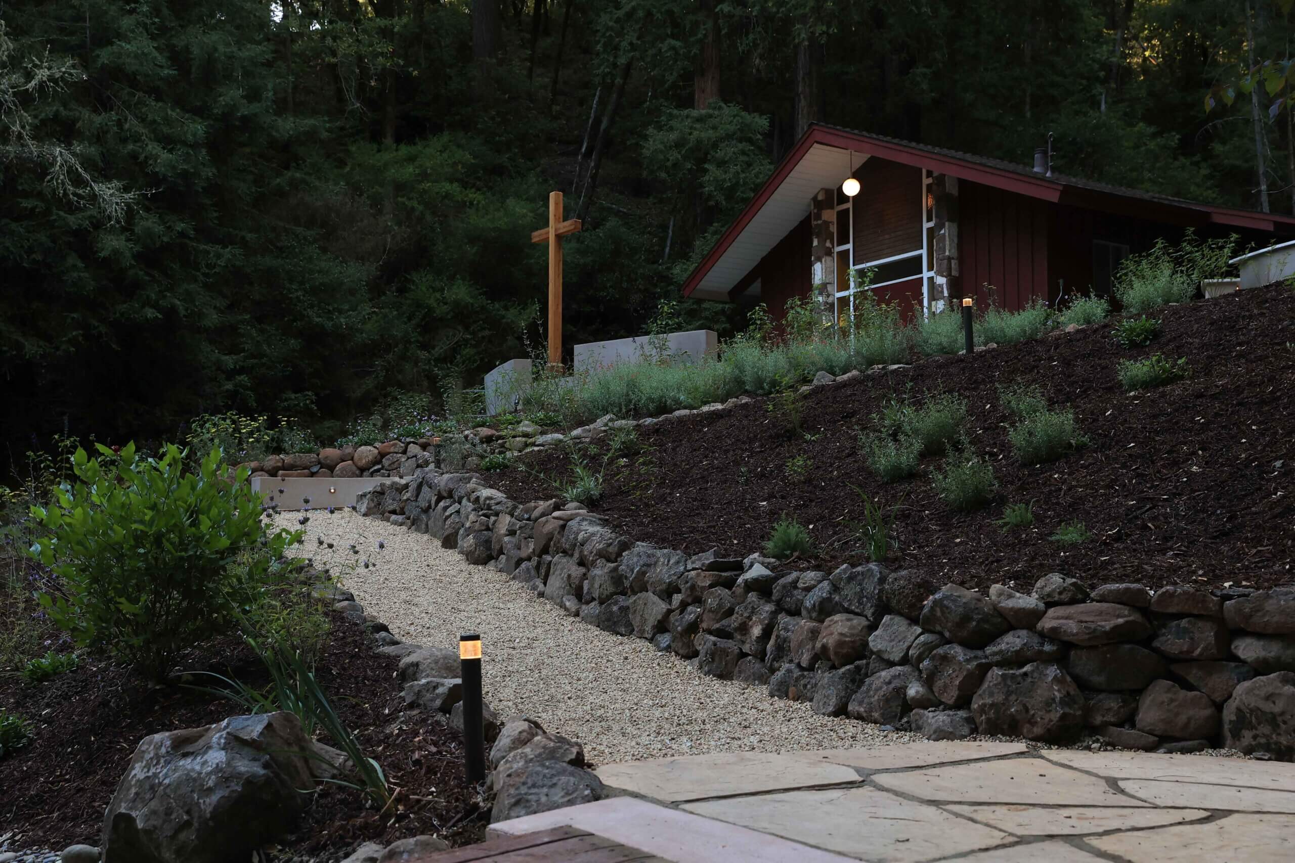 Naturalistic landscape design blending built features with existing woodland surroundings by K&D Landscaping