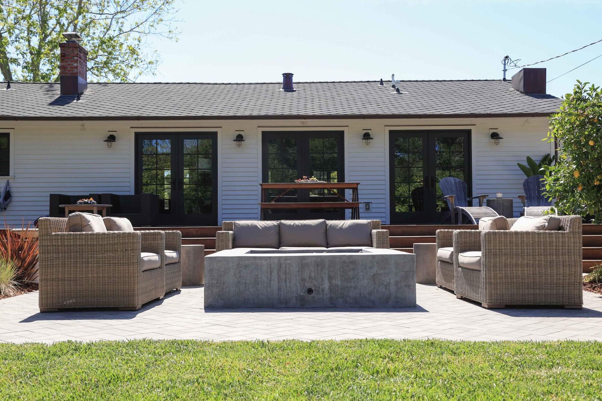 Outdoor kitchen and gathering area integrated into a residential landscape by K&D Landscaping