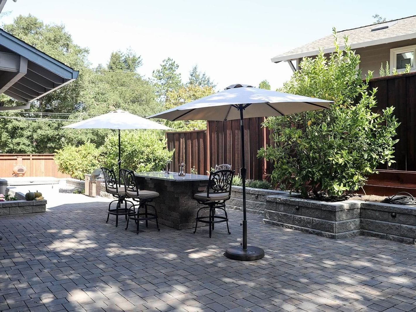 Outdoor living area with custom kitchen and landscape lighting by K&D Landscaping