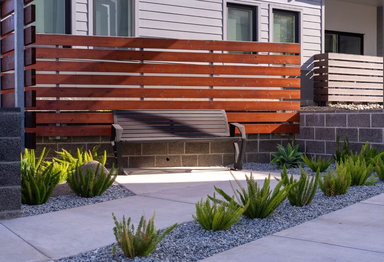 Outdoor seating area integrated into apartment community landscape by K&D Landscaping