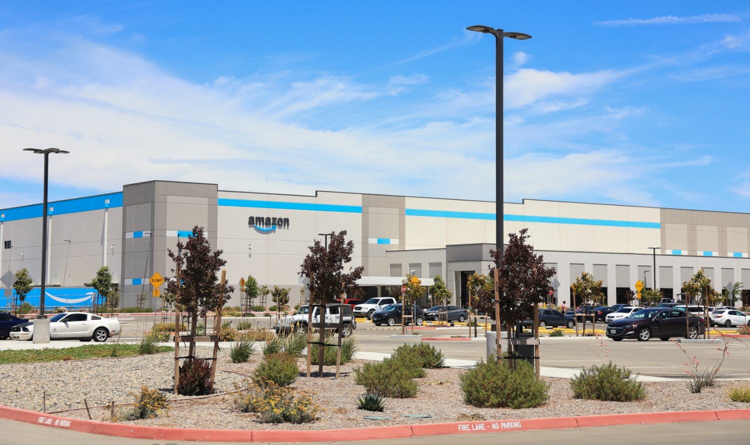 Professional landscape installation by K&D Landscaping supporting a large fulfillment facility