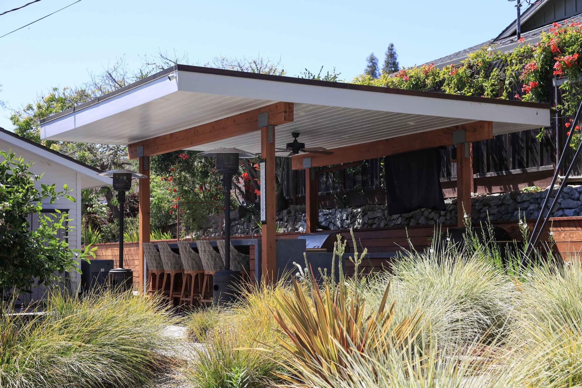 Professionally designed backyard with lawn, plantings, and hardscape features by K&D Landscaping