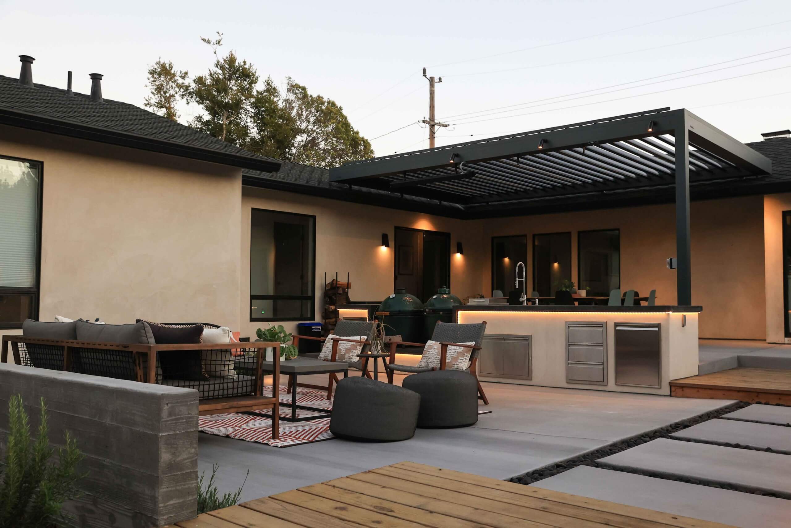 Professionally designed backyard with lawn, plantings, and outdoor seating by K&D Landscaping